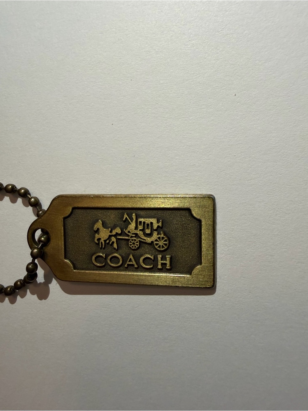 Coach Brass Tone Logo Tag Keychain - Antique Gold